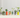 A row of potted plants displayed in upcycled beer cans with vibrant designs, against a white corrugated background.