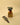 Small potted plant on a wooden block with a pair of shears on a beige background