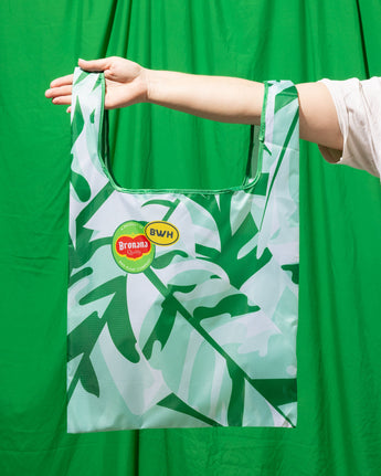 A reusable green tote bag with a camouflage pattern, featuring the Bronana logo.