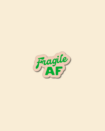 A custom-shaped, glossy sticker with the script text 'Fragile AF' in green on a beige background.