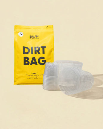Yellow 'Dirt Bag' package with clear clear grow pots on a beige background