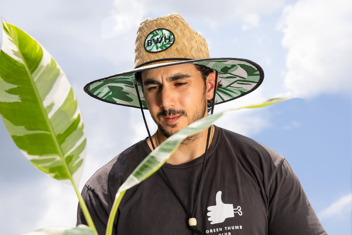 A person wearing a straw hat with a 