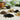 small piles on white table of soil amendments such as moss and charcoal