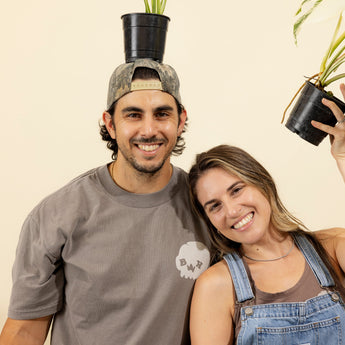 Couple posing with plants